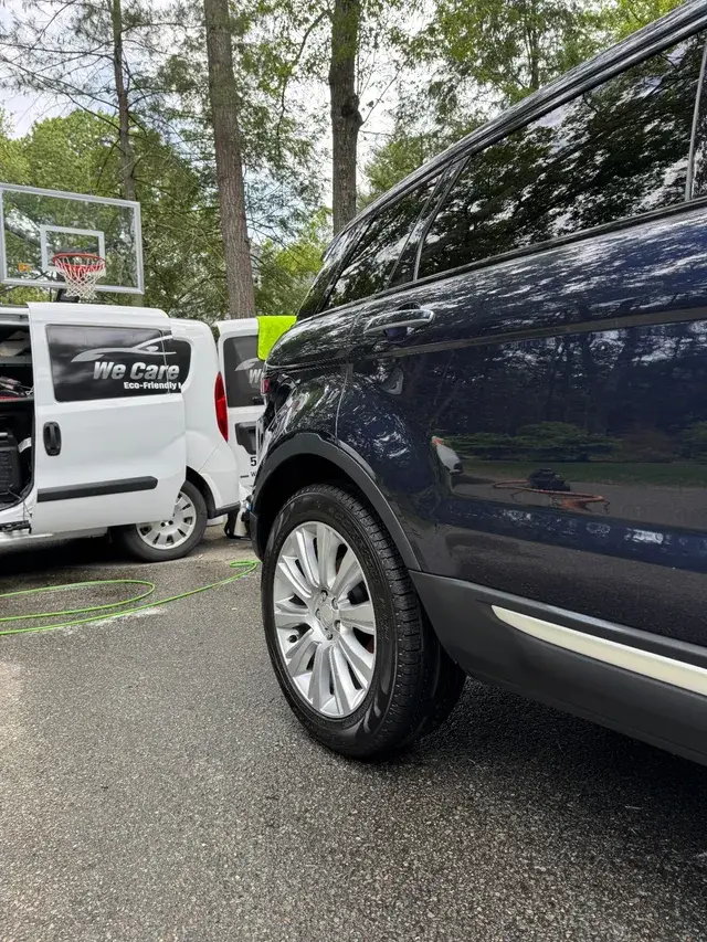 Glossy dark SUV with mirror-like finish after mobile detailing by We Care Car Care