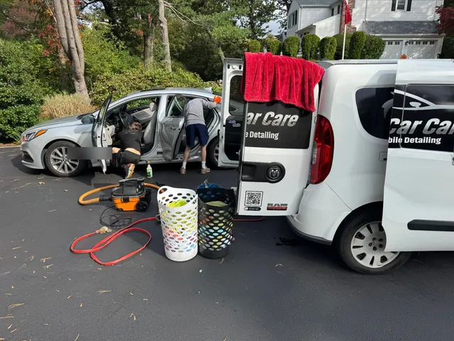 We Care Car Care mobile detailing team working on-site at a customer's home