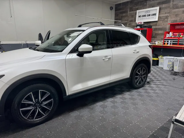 White Mazda CX-5 side profile in We Care Car Care studio